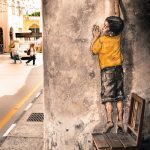 boy on chair street art mural Penang