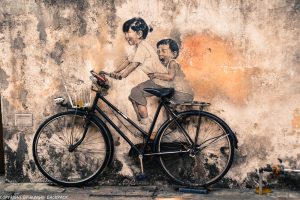Children on bicycle famous street art mural Penang