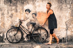 children on bicycle famous street art mural Penang