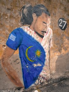 man with flag_street art mural Penang