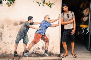 two guys pushing street art mural Penang