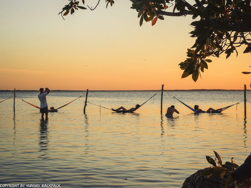 Explore Holbox on a budget_watching couples taking sunset hammock pictures