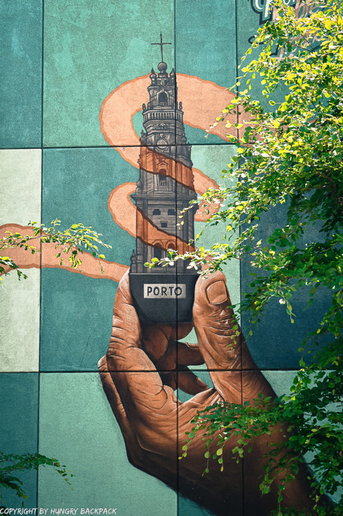 Porto street art_Trinidade_Mr Dheo holding Clerigos Tower