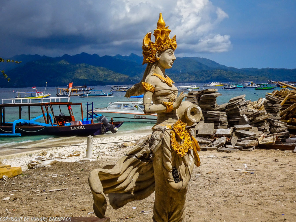Gili Trawangan on year after earthquake_construction work at beach with statue