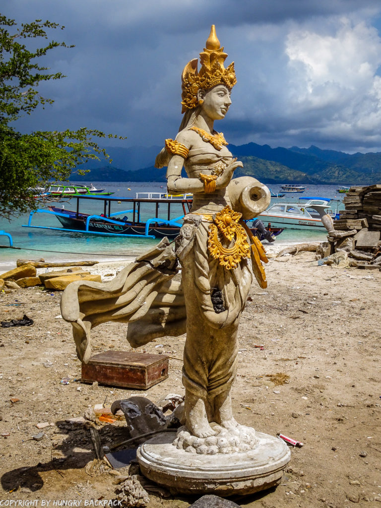 Gili Trawangan on year after earthquake_construction work at beach with statue